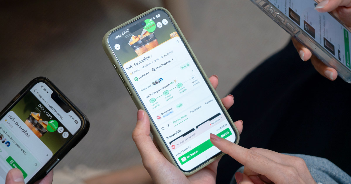A close-up of people using a food delivery app on their smartphones.
