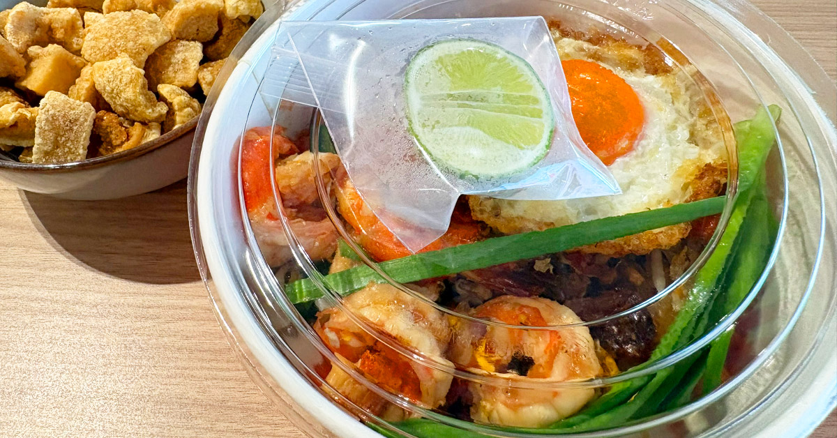A takeaway meal placed on a wooden table.