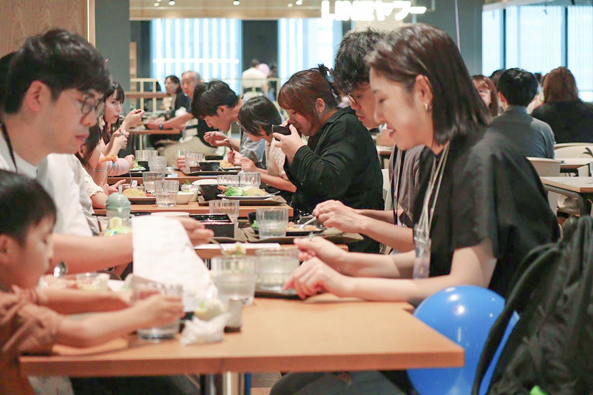 参加者がテーブルを囲み、赤坂オフィスのDiningで食事を楽しんでいる写真