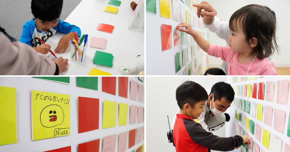 子供がカードにメッセージを書く様子の写真